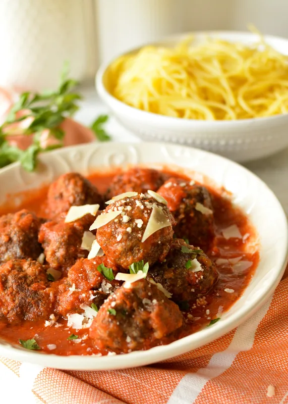 Fresh gluten-free meatballs with ingredients on a wooden board